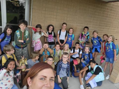 Mrs. Camit with her class outside holding the Spirit Trophy