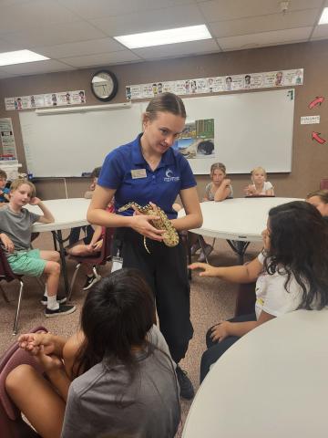 Living Aquarium teacher showing students a snake