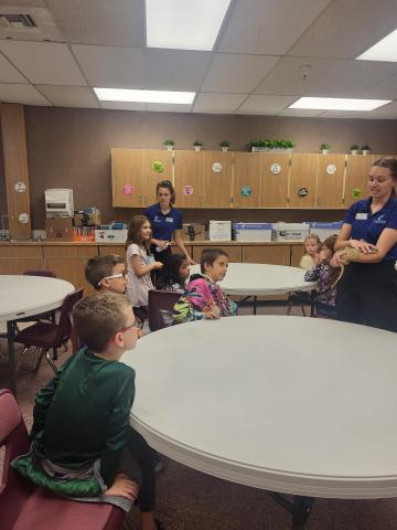 Living Aquarium teacher showing students a snake