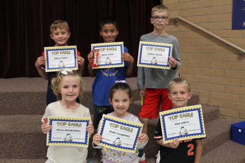 Six top eagle students holding their certificates. 