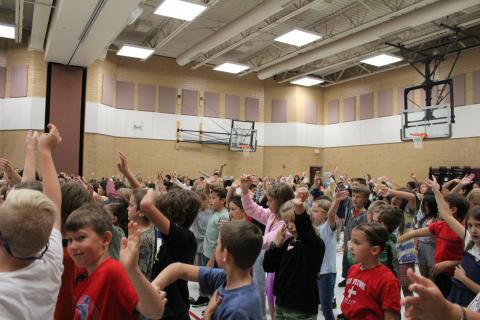 Students dancing, waving their arms