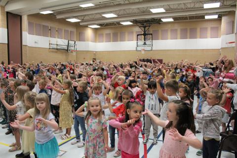 Students dancing, waving their arms