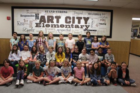 Full student council in front of the Art City Elementary sign