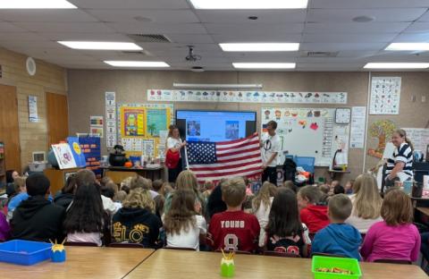 Conner Mantz and Mrs. Mantz holding the American Flag