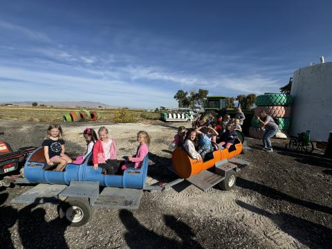 Kindergarten students riding on the farm train. 