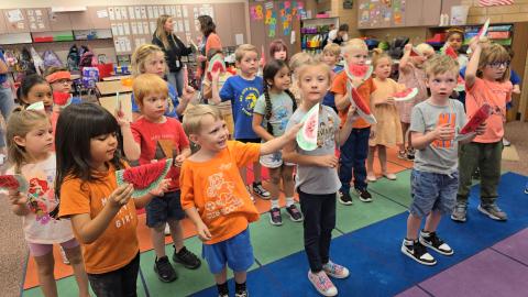 Kindergarten students dancing with there watermelon shakers