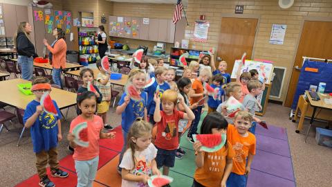 Kindergarten students dancing with there watermelon shakers