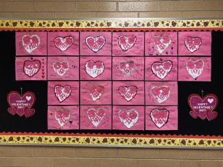 Bulletin Board:  Hearts made with handprints 