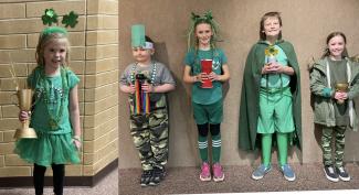 One Child from each grade dressed in green-five children in all two boys and three girls.  All holding a unique trophy. 