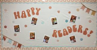 Happy Readers bulletin board with pictures of seven 5th grade students and their favorite book. 